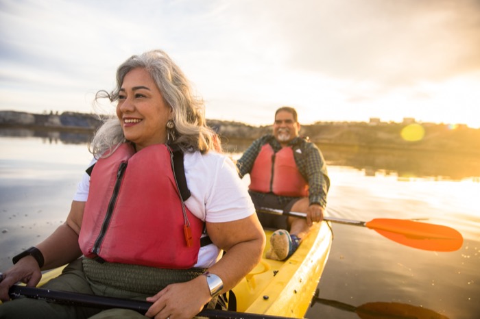 Retired couple kayaking at sunset, representing LACERA pension beneficiaries