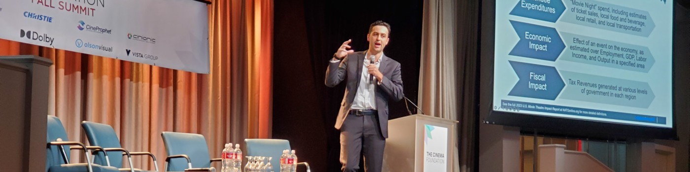 Samuel Maury-Holmes presenting economic impact findings at a conference