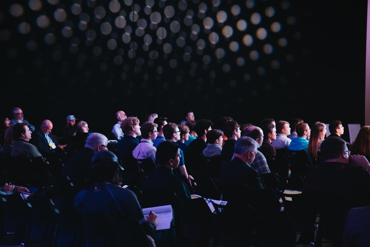 Industry association conference attendees seated in an auditorium listening to a presentation